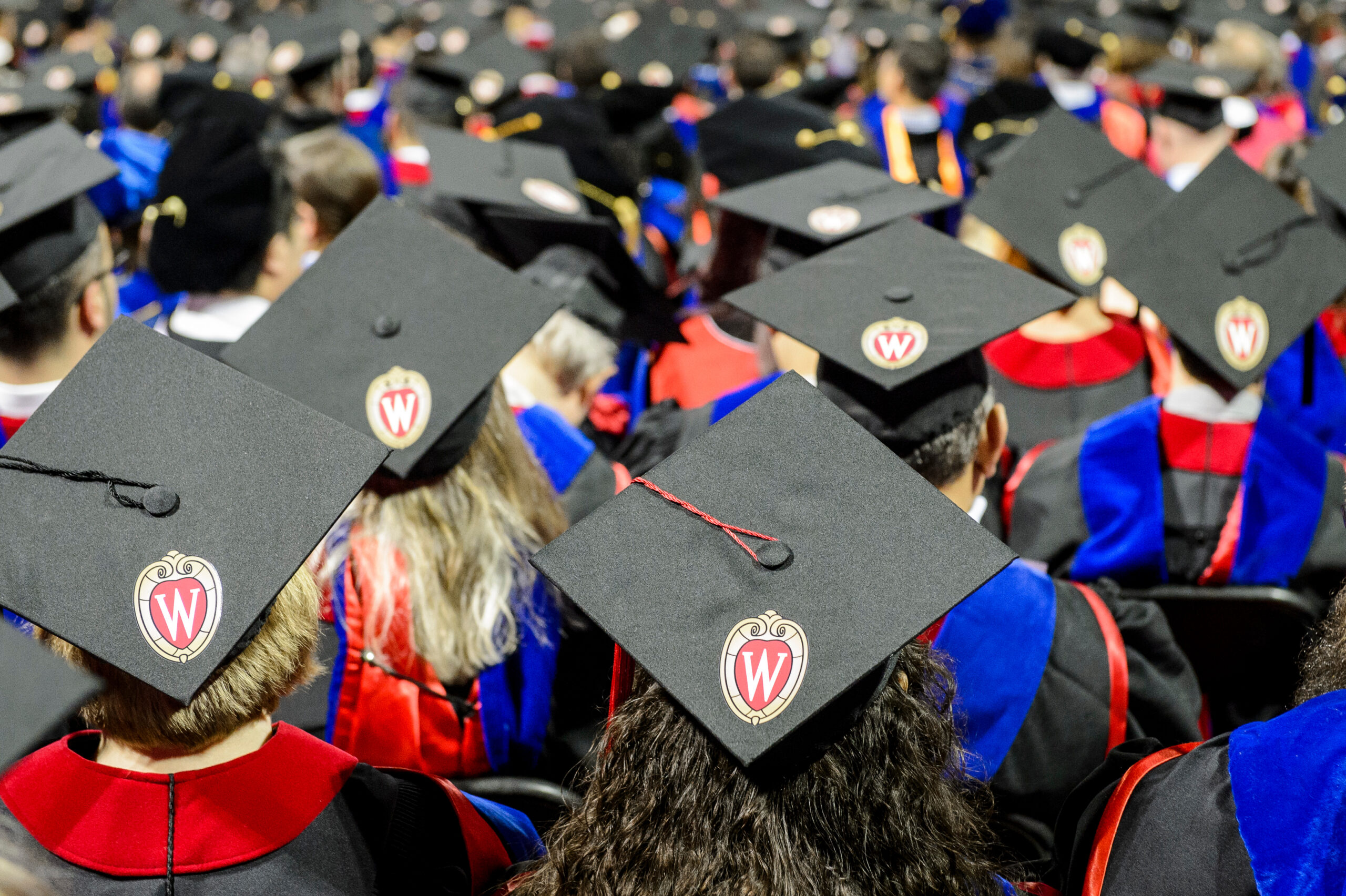 a crowd of people wearing graduation caps